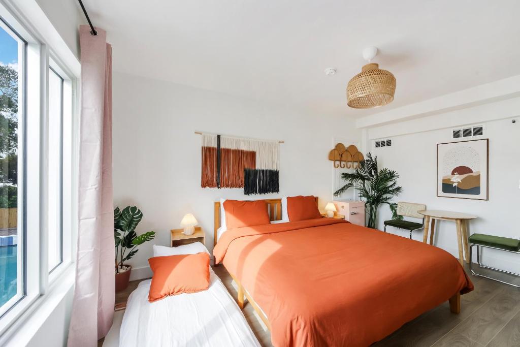 A bright and airy hotel room with a large bed, two nightstands, and a window
